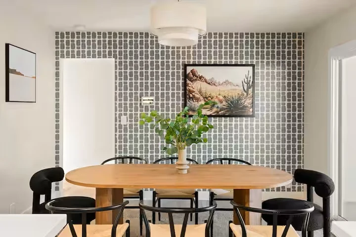 Dining room with oval table and desert artwork